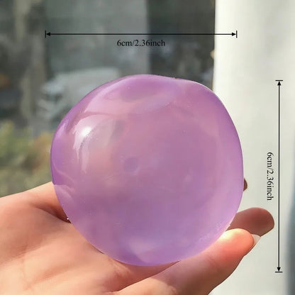 Coconut Oil Squishy stress ball, 6cm across, held in a hand